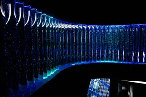 a curved glass wall in a dark room
