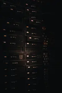 a large stack of drawers in a dark room
